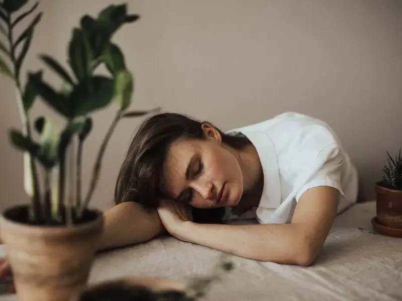 Woman with autoimmune illness sleeping at her desk.